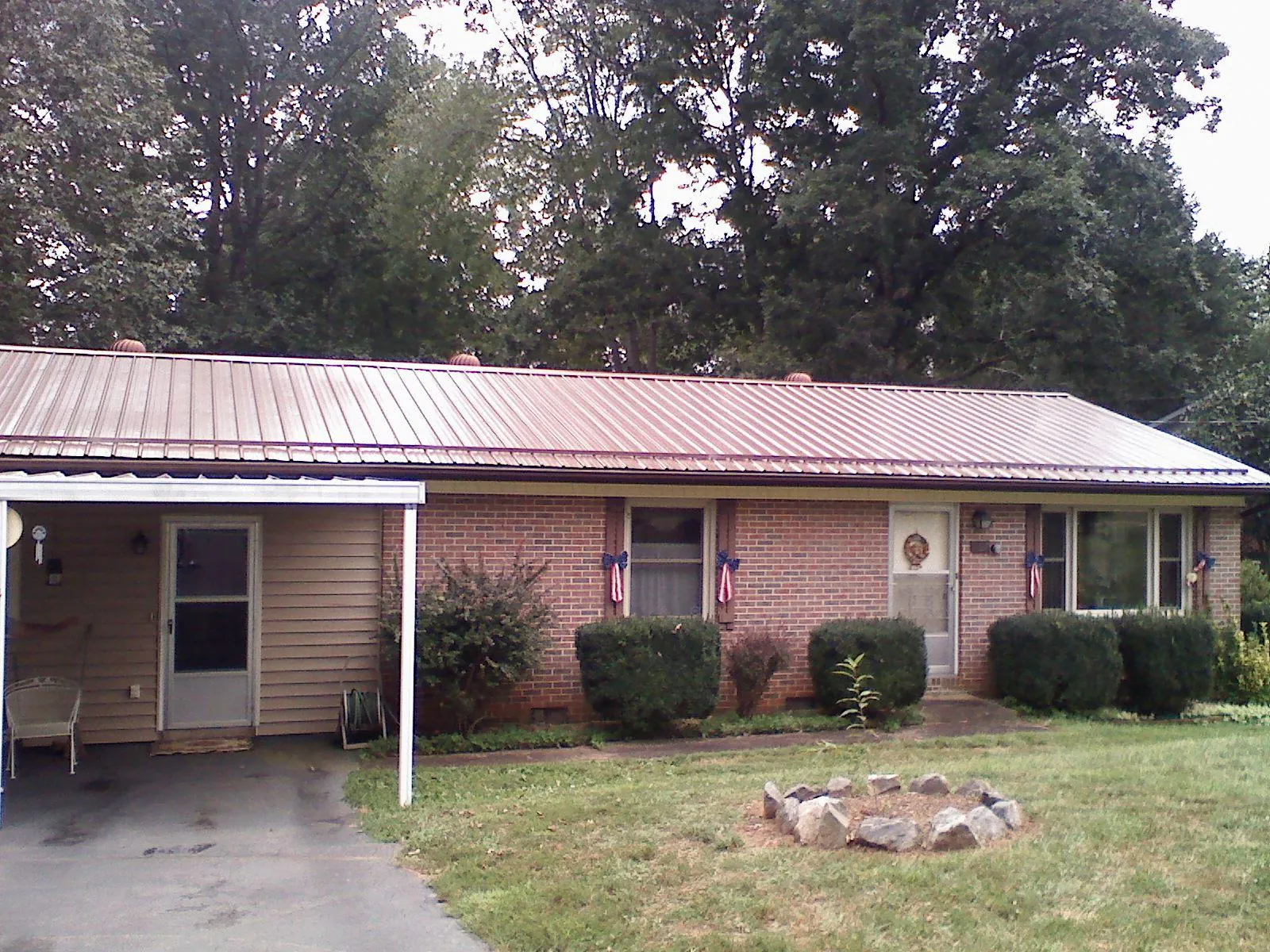 Bronze metal roof and carport on a brick ranch home — Roof Repair work by our crew in Mount Royal