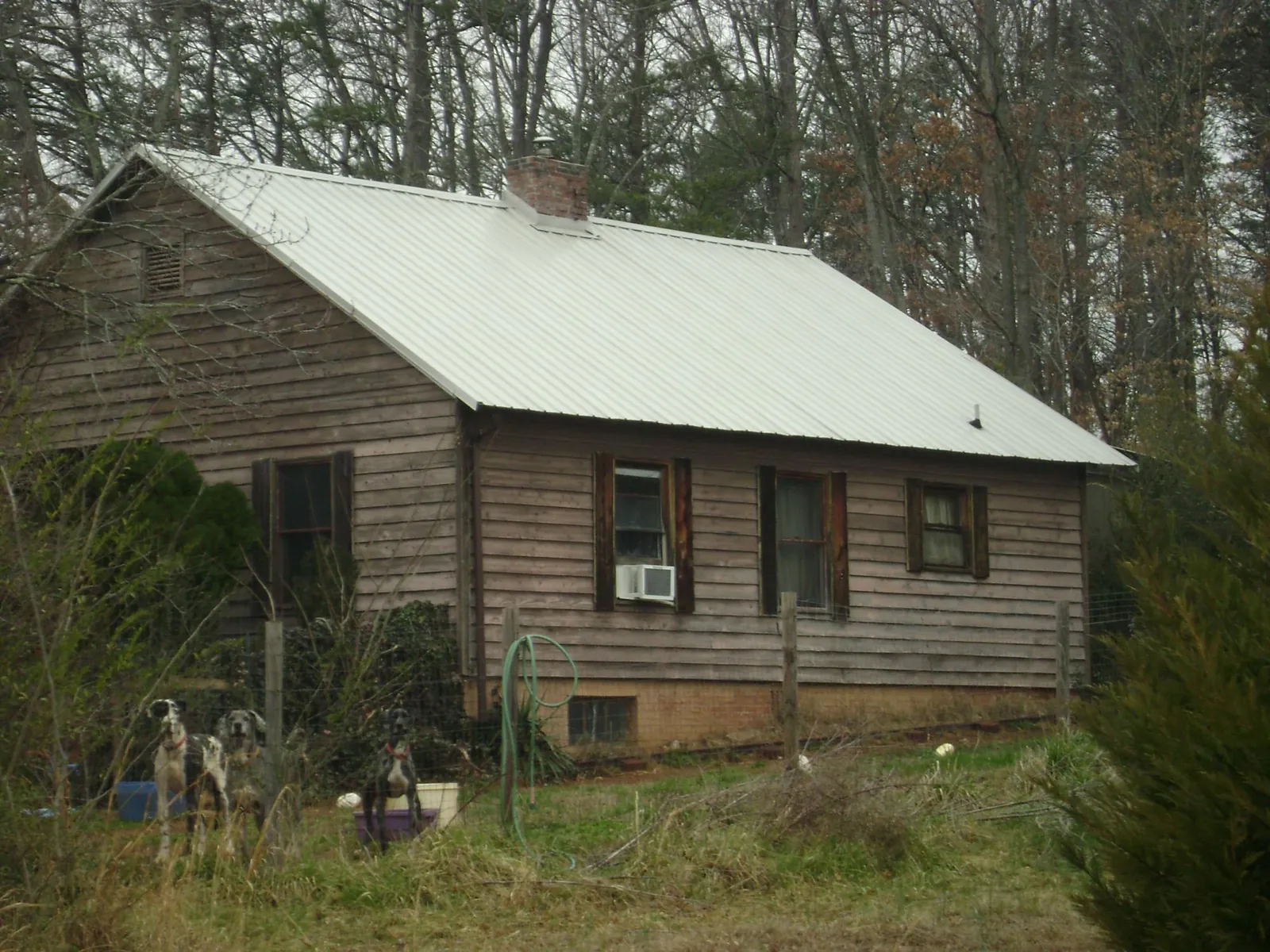 White metal roof on an old wood sided farmhouse, from a Asphalt Shingle Roof Repair job in Mount Royal